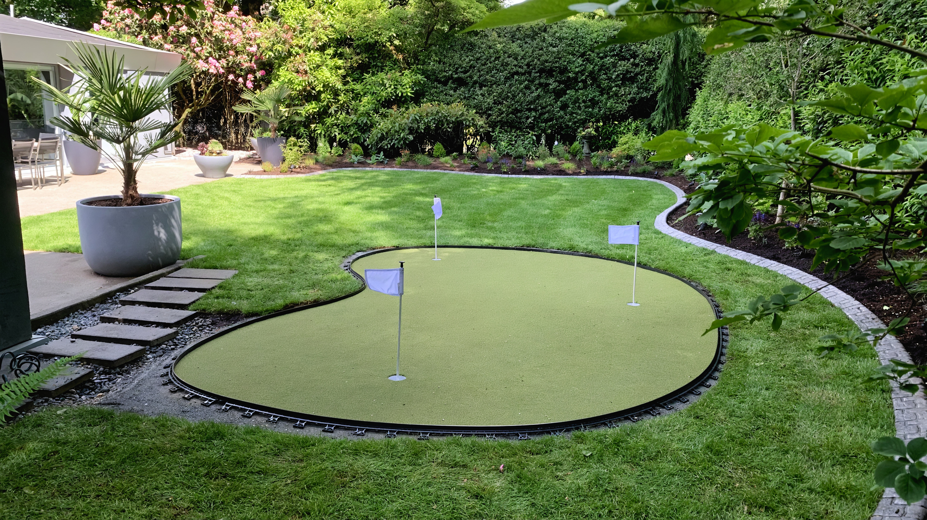 Sod lawn, Outdoor Lighting, Putting green and Concrete walkway at the Cartier St project.
